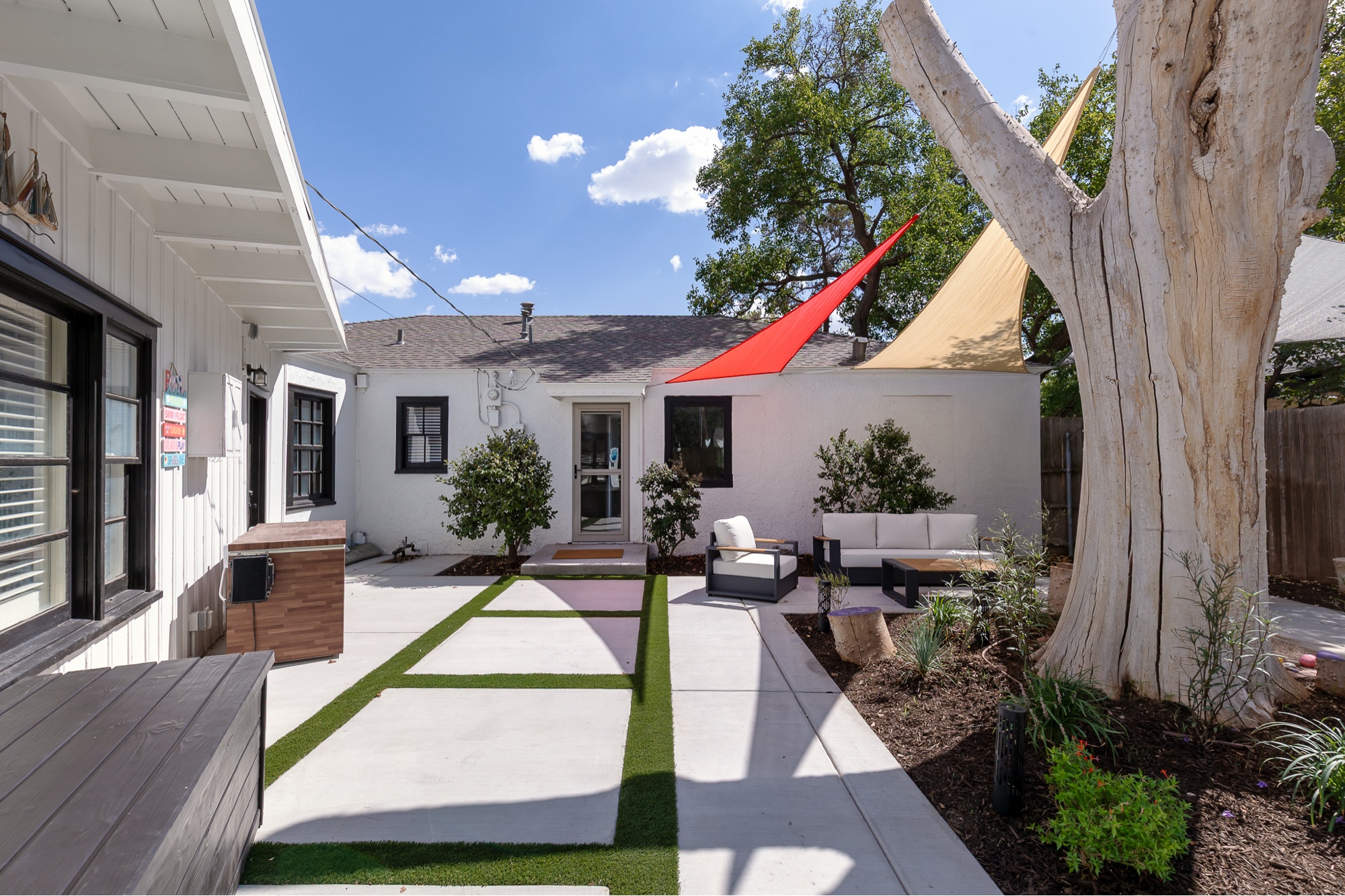 Front patio with red and cream shade sails
